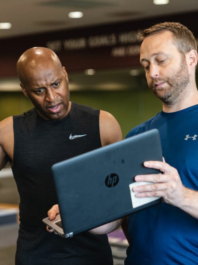 Personal trainer demonstrating functional movements to client