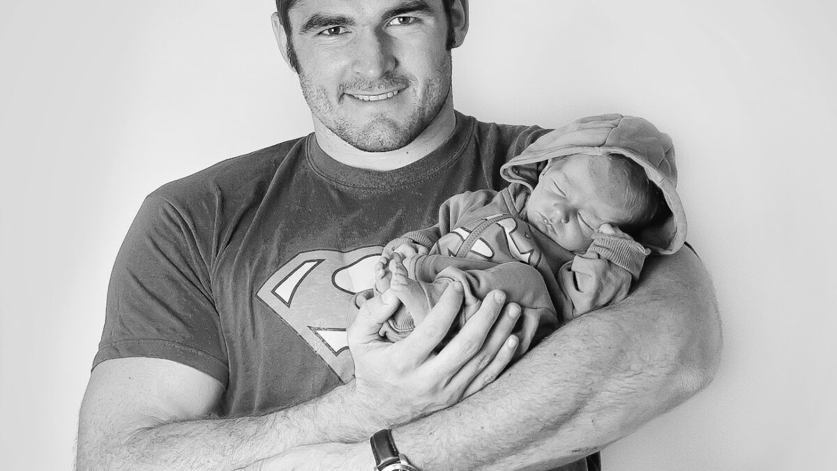 Don Armand holding his baby